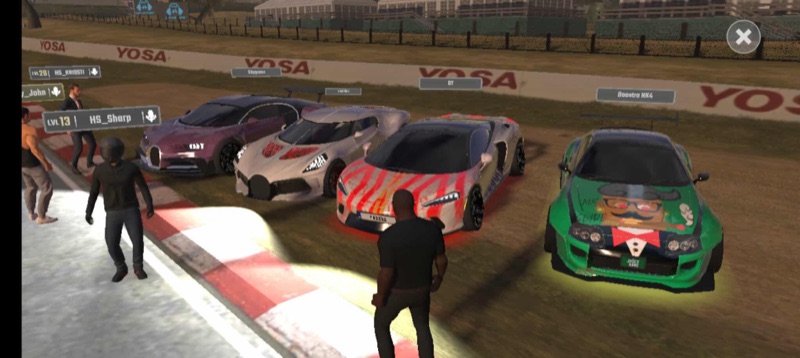 Players gathered around customized cars at a racetrack meet-up
